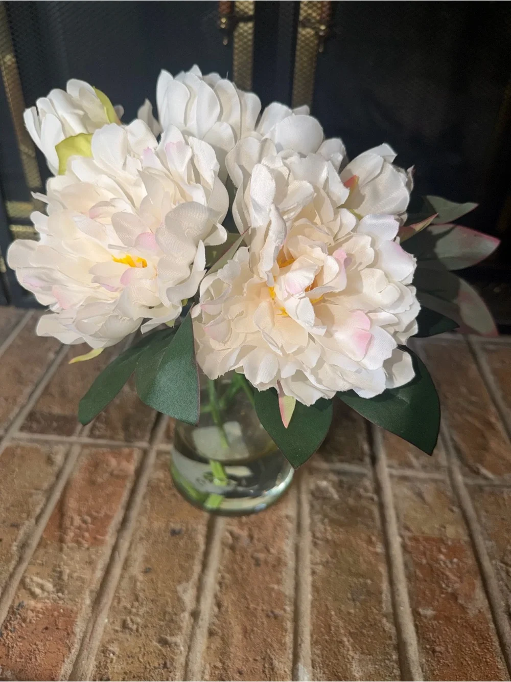 11” cute white bouquet flowers anchored in glass vase